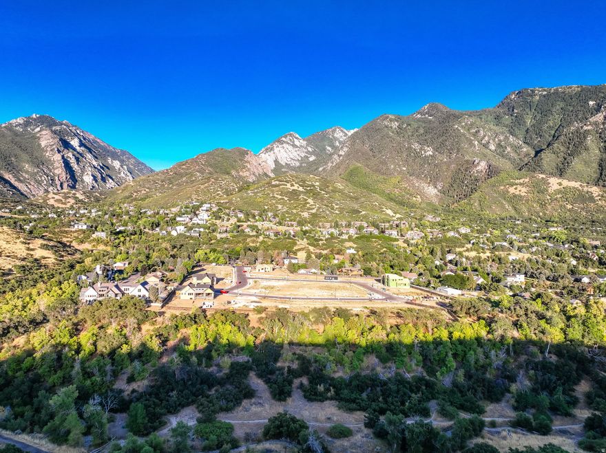 Discover one of the most extraordinary building sites in all of Salt Lake County-a truly majestic parcel in the coveted Orchards at Dimple Dell, where only a handful of lots remain in this exclusive Sandy community perched along the Wasatch Front. With the commanding face of Lone Peak rising dramatically in front and the pristine, protected expanse of Dimple Dell Regional Park bordering your backyard, this rare property delivers forever views, absolute privacy that no future development can touch, and immediate access to some of the region's premier equestrian trails, hiking paths, and mountain biking routes right from your property line. Nestled among luxurious estates valued between $2.5M and $5M+, and just minutes from the gateway to Big Cottonwood Canyon and world-class skiing, this is a singular opportunity to craft your dream-whether a tranquil mountain sanctuary or an impressive legacy estate-with the flexibility to work with our trusted builder recommendations or bring your own team to create your custom masterpiece. Seize this once-in-a-lifetime chance to claim one of the most enviable and irreplaceable properties on the Wasatch Front before it's gone.