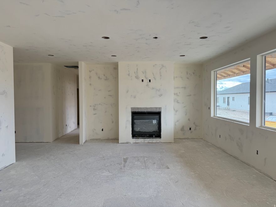 UNDER CONSTRUCTION - Estimated Completion: January 1, 2026   Welcome to this beautifully crafted custom home in the desirable Monroe Hot Springs Subdivision in Monroe, Utah. Nestled on a .28-acre corner lot with breathtaking mountain views, this single-level residence offers the perfect blend of comfort, style, and thoughtful design. Featuring 1,972 sq. ft. of well-planned living space, this 3-bedroom, 2-bathroom home showcases an open-concept layout with expansive windows that flood the living and kitchen areas with natural light. The heart of the home includes a custom-built fireplace with built-ins, a large kitchen island, and an oversized butler's pantry complete with a sink, custom cabinetry, and a built-in drinking fountain-ideal for both everyday use and entertaining. The luxurious primary suite offers generous space and direct access to the back patio, while the additional bedrooms provide comfort and flexibility for family, guests, or a home office. The tiled shower with a full-glass enclosure adds a touch of spa-like elegance to the primary bath. Whether you're sipping coffee on the front porch, enjoying the mountain scenery, or hosting gatherings in your designer kitchen, this home is built to impress-inside and out.