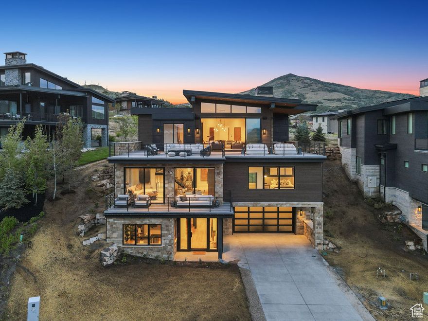 Designed by JSARC, built by MW Watts Construction, and interior finishes and furnishings by Bassman Blaine Home. This home is beautifully designed, well-built, and has all the bells and whistles. With 5 bedrooms, 7 bathrooms, a private office, a theater with seating for 8, a sprawling 1,200+ square foot garage, and over 2,000 square feet of heated patios and decks, this home seamlessly blends refined luxury with breathtaking views of Deer Valley's mountains and the Jordanelle Reservoir-offering the perfect launchpad for all your upcoming adventures. 5th bedroom is currently outfitted as an office. Features radiant heat throughout, a heated driveway and decks, Pella windows and doors, Wolf and Subzero appliances, custom closets in every bedroom, an in-ground hot tub, a Control4 system for audio, lighting, and shades. The home is also framed and prewired to add an elevator for future convenience. The home is being sold turnkey, including everything from the furnishings and the accessories, including Luxury Saatva Classic mattresses, Peacock Alley linens and towels, a Vitamix in the pantry, and more. The SkyRidge community is surrounded by miles of paved and dirt trails, is located less than 5 minutes from the Jordanelle Reservoir and Deer Valley Mountain Resort, and features a private shuttle that will pick you up at your door and take you directly to Deer Valley's East Village or Jordanelle Gondola. In addition, numerous amenities are underway, including an Equestrian center that is nearing completion and scheduled to be fully operational in 2026. This 3-hole Mountain golf course can convert into a 9-hole short course plus a driving range. This community clubhouse is expected to open in 2026, where owners will enjoy access to a pool and fitness studio, and a boutique hotel with a spa, restaurant, and rooftop bar, making SkyRidge an even more complete destination, no matter if you are looking for a primary or vacation home.