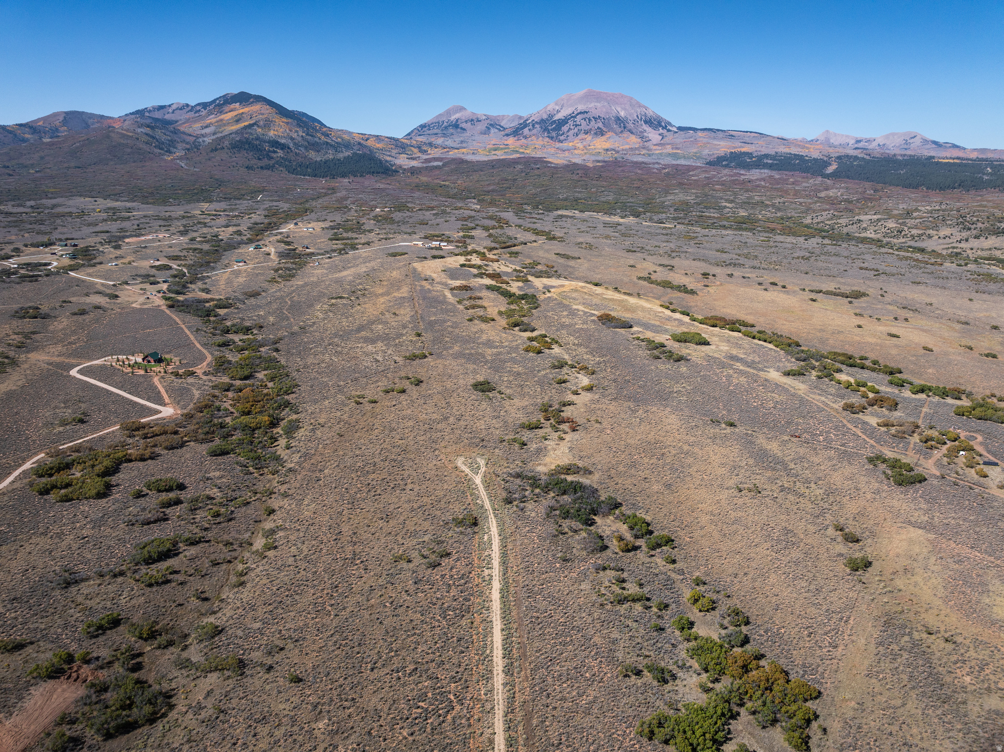 Expansive acreage featuring natural vegetation and distant mountain ranges