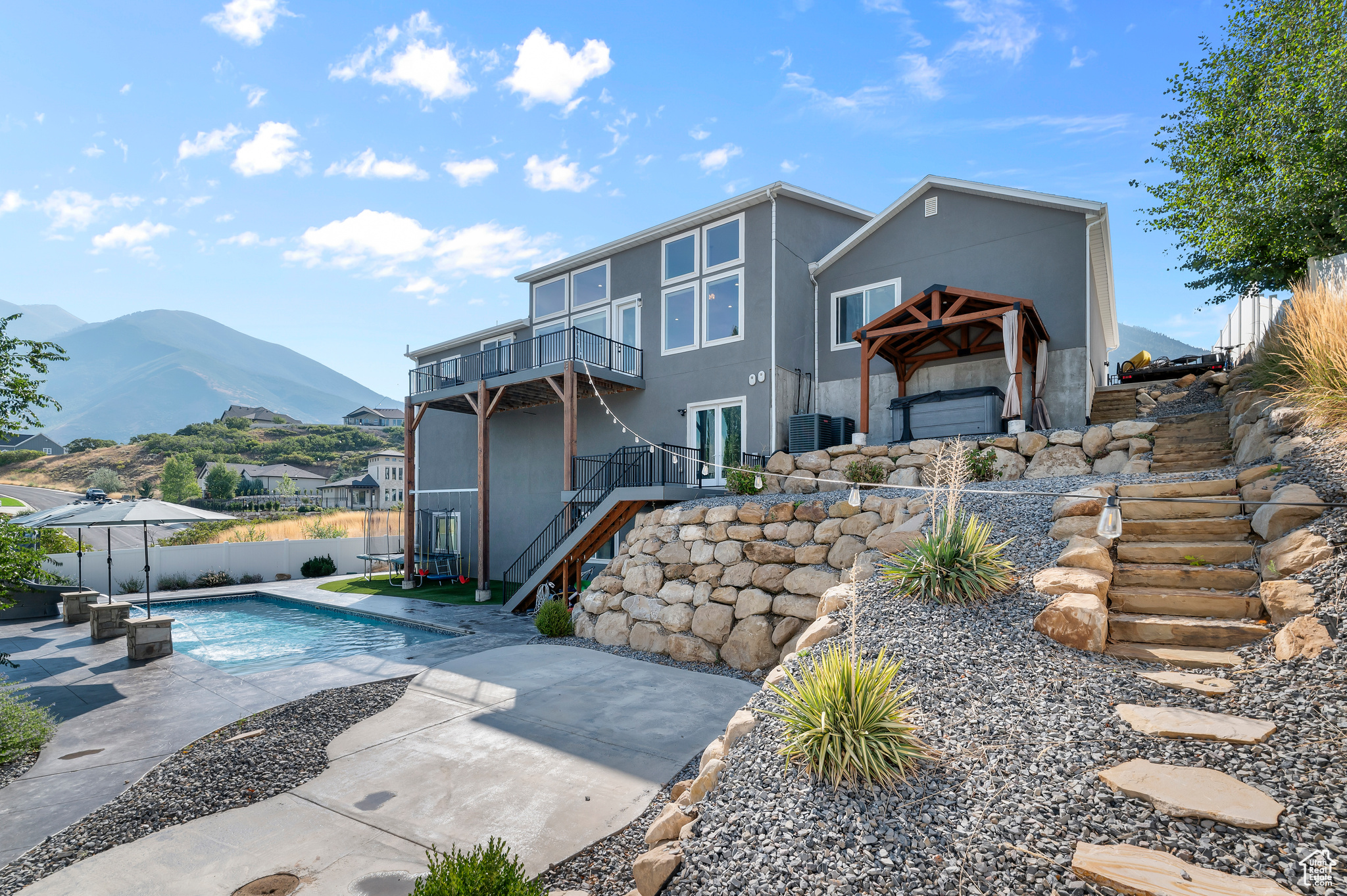 **SELLER IS OFFERING A $15,000 INCENTIVE TO BE USED AT BUYER'S DISCRETION TOWARD CLOSING COSTS OR RATE BUYDOWN**Every entertainer's dream and the ultimate retreat! This Spanish Fork masterpiece offers jaw-dropping views that will have you sold the second you step inside, paired with unforgettable amenities that set this home apart from the rest. Designed for luxury, fun, and convenience, this home brings your dreams to life with a resort-style backyard featuring a sparkling heated pool and slide, relaxing hot tub, and expansive decks for breathtaking sunsets. Inside, you'll find soaring ceilings, a chef's kitchen built for gatherings, and your very own indoor basketball court, along with a private theater, golf simulator, second kitchen, and convenient main-level living. A 4-car tandem garage and RV parking on both sides of the property complete the package. Crafted with luxury in mind and designed as the ultimate entertainer's paradise, there is truly nothing else like it on the market. Perfectly located near the Spanish Fork Reservoir and golf course, this retreat offers not only unmatched amenities but also an unbeatable lifestyle. Square footage figures are provided as a courtesy estimate; Buyers are encouraged to obtain an independent measurement. Owner/Agent.
