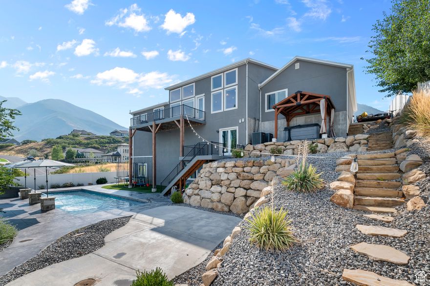 **SELLER IS OFFERING A $15,000 INCENTIVE TO BE USED AT BUYER'S DISCRETION TOWARD CLOSING COSTS OR RATE BUYDOWN**Every entertainer's dream and the ultimate retreat! This Spanish Fork masterpiece offers jaw-dropping views that will have you sold the second you step inside, paired with unforgettable amenities that set this home apart from the rest. Designed for luxury, fun, and convenience, this home brings your dreams to life with a resort-style backyard featuring a sparkling heated pool and slide, relaxing hot tub, and expansive decks for breathtaking sunsets. Inside, you'll find soaring ceilings, a chef's kitchen built for gatherings, and your very own indoor basketball court, along with a private theater, golf simulator, second kitchen, and convenient main-level living. A 4-car tandem garage and RV parking on both sides of the property complete the package. Crafted with luxury in mind and designed as the ultimate entertainer's paradise, there is truly nothing else like it on the market. Perfectly located near the Spanish Fork Reservoir and golf course, this retreat offers not only unmatched amenities but also an unbeatable lifestyle. Square footage figures are provided as a courtesy estimate; Buyers are encouraged to obtain an independent measurement. Owner/Agent.