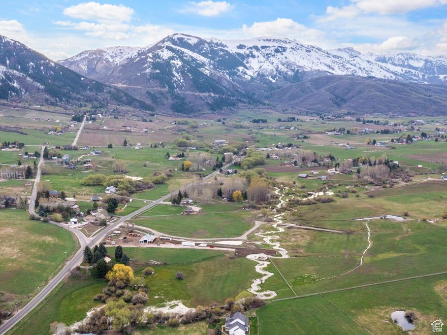 Nestled in the serene landscape of Eden, Utah, this extraordinary 40.95-acre property offers a rare opportunity to own a piece of pristine land. Featuring a charming 1,440 sq. ft. home with 2 bedrooms and 1 bathroom, this estate is designed for both comfort and self-sufficiency. With 32 water shares, 2 wells, and a recently upgraded interior-including new carpet, a new furnace, and an instant hot water heater-the home blends modern convenience with rustic charm. Adjacent to a year-round water source and surrounded by picturesque cattle ranches, the property offers breathtaking views of Ogden Valley and endless potential for agricultural pursuits. A spacious 1,400 sq. ft. barn adds to its versatility. The seller is offering financing at a 3% interest rate with a 50% down payment. All boundary lines and square footage figures are provided as a courtesy estimate; buyers are encouraged to obtain an independent measurement.