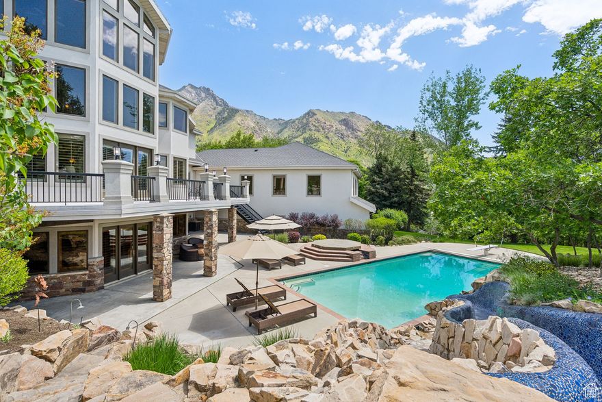 PRIVACY, PRESTIGE, and PANORAMIC VIEWS. Set at the end of a quiet cul-de-sac on 2.16 acres, this Alpine estate offers seclusion, panoramic Wasatch views, and year-round amenities right at home. The grounds live like a personal park with a resort-style pool, expansive patios, mature landscaping, and room to roam. Inside, generous living and dining areas flow effortlessly outdoors, with natural light and mountain vistas at every turn. A rare amenity, the full-height indoor sport court keeps the action going in every season. Flexible rooms adapt to today's lifestyles-office, fitness, media, or guest spaces-while the acreage leaves room to grow. Just steps from Lambert Park's extensive hiking and biking trails, yet minutes from Alpine's schools, shops, and commuter routes, this residence delivers the perfect balance of retreat and convenience. Built by Magleby and once home to baseball legend Dale Murphy, it pairs craftsmanship and cachet with an unrivaled Alpine setting. Shown by appointment.
