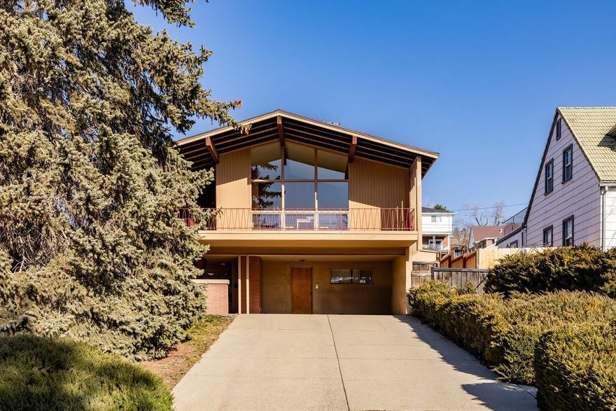 A magical mid-century modern gem, beautifully preserved. Stunning views from the vaulted living room which has floor-to-ceiling windows and a wraparound fireplace. Classic I-beam construction and warm birch paneling throughout celebrate the mid-century design. A large deck overlooking the city creates the perfect setting for relaxing or entertaining.  The lower-level living space is mostly above grade, with skyline views, open areas and a small kitchen great for guests, work, or recreation. Outside is a charming covered patio and a backyard retreat. Set high up in a quiet Avenues location this home is walkable to restaurants, grocery stores, City Creek Canyon, and just one block to the public library. Pristine, thoughtfully maintained, and ready for personal refresh, this exceptional home is a rare find.