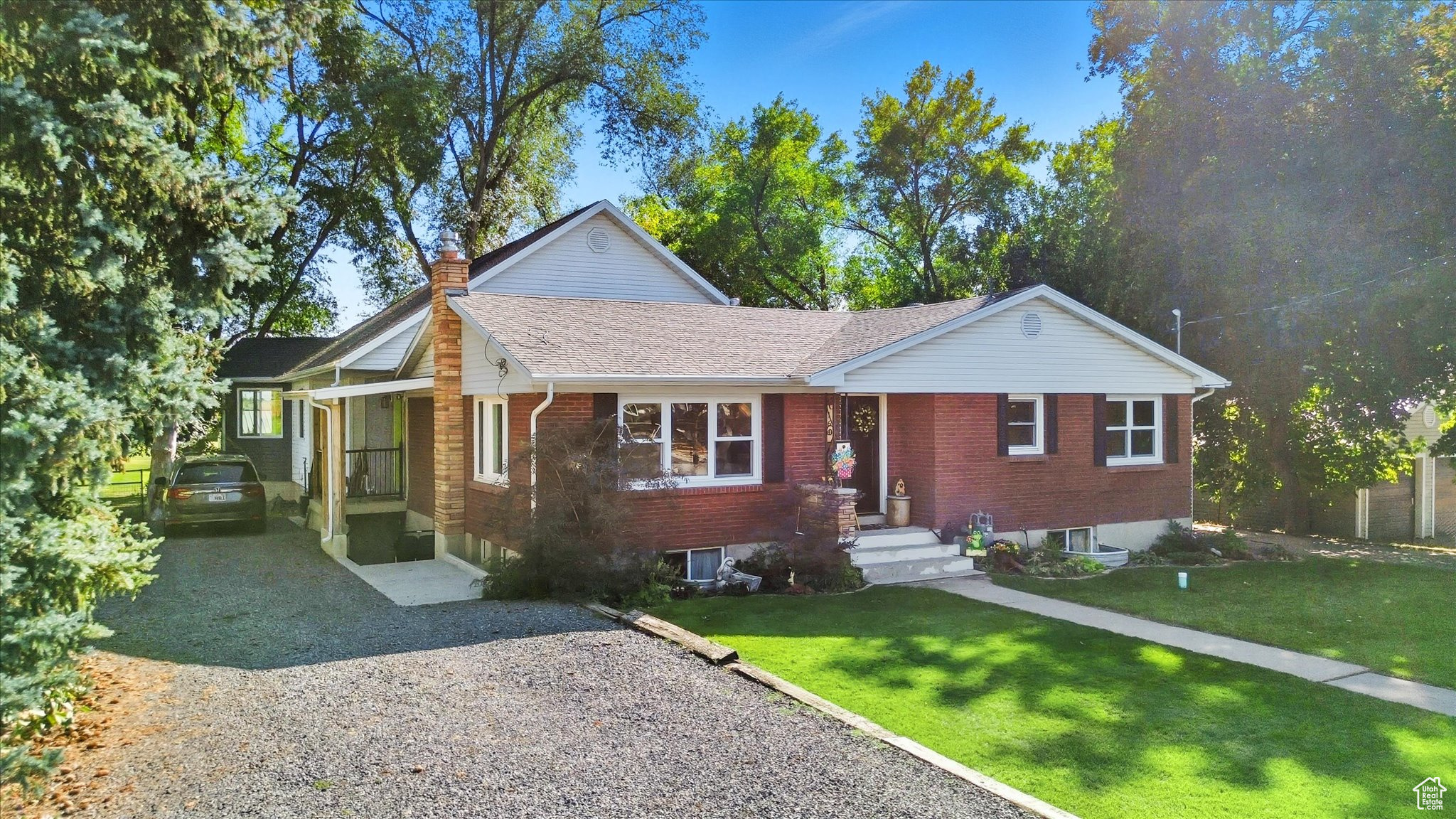 UNIQUE doesn't even begin to describe this property. It has endless possibilities. The home includes 3 kitchens, 3 separate living spaces, options galore. The finishes throughout the entire home are gorgeous with colorful trim, brick walls, unique layouts, custom cabinetry and beautiful flooring. A large family could occupy main floor living and basement then still have a mother in law apartment, or separate living spaces with extended family. There are too many options to list. 7 bedrooms could be 8, 5 bathrooms and sitting on 1.76 acres with 2 out buildings while being surrounded with beautiful established trees. This property boasts panoramic Cache Valley views and spectacular sunsets. Property includes 1 1/2 shares of water along with the ability to have 3 horses, stalls and tack room or space for other animals. It really is one you have to see in person to appreciate all the detail to the home, the options it could provide, and the amazing yard. Square footage figures are provided as a courtesy estimate only and were obtained from county . Buyer is advised to obtain an independent measurement.