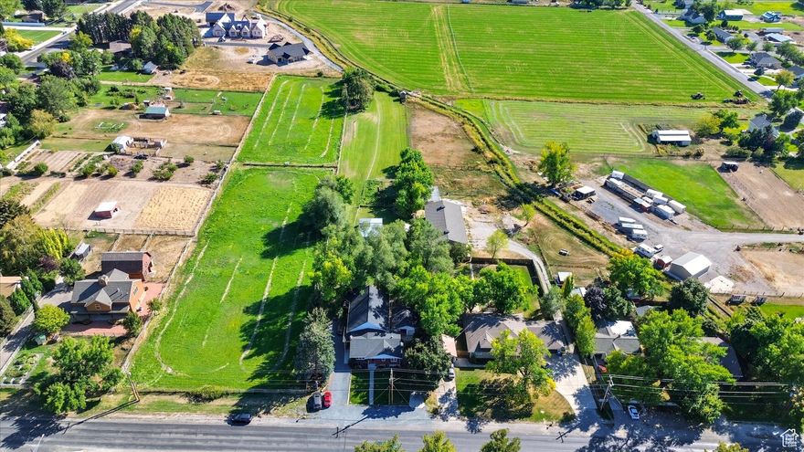 UNIQUE doesn't even begin to describe this property.  It has endless possibilities.  Home is effectively built in 2020.  The sellers did a full remodel on current home then added over 3200 square feet in the addition built in 2020.  The home includes 3 kitchens, 3 separate living spaces, options galore.   The finishes throughout the entire home are gorgeous with colorful trim, brick walls, unique layouts, custom cabinetry and beautiful flooring.  A large family could occupy main floor living and basement then still have a mother in law apartment, or separate living spaces with extended family.  There are too many options to list. 7 bedrooms could be 8, 5 bathrooms and sitting on 1.76 acres with 2 out buildings while being surrounded with beautiful established trees.  This property boasts panoramic Cache Valley views and spectacular sunsets. Property includes 1 1/2 shares of water along with the ability to have 3 horses, stalls and tack room or space for other animals.  It really is one you have to see in person to appreciate all the detail to the home, the options it could provide, and the amazing yard.  Square footage figures are provided as a courtesy estimate only and were obtained from county .  Buyer is advised to obtain an independent measurement.