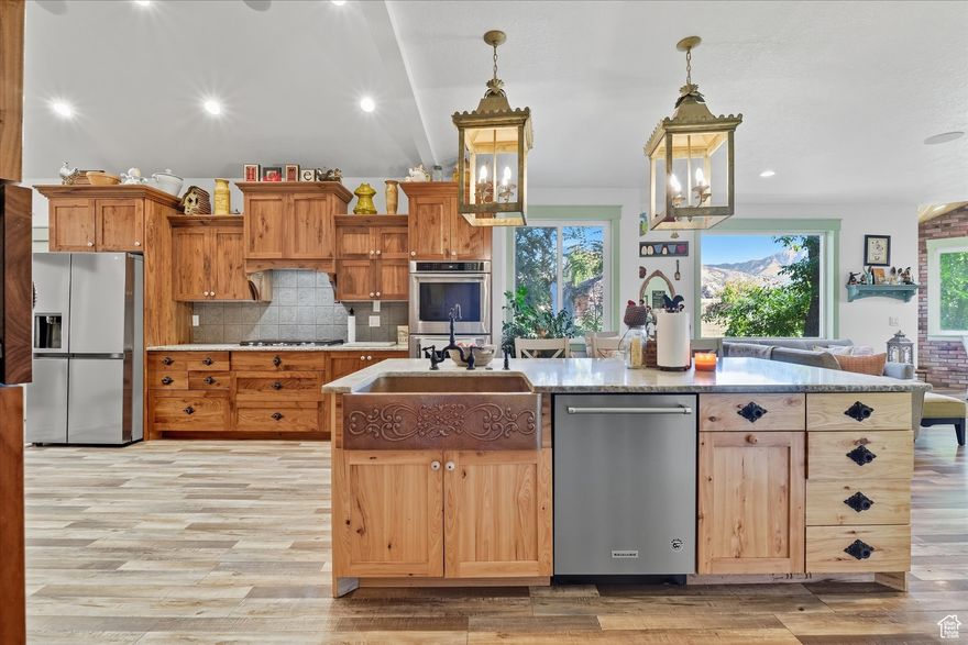 UNIQUE doesn't even begin to describe this property.  It has endless possibilities.  Home is effectively built in 2020.  The sellers did a full remodel on current home then added over 3200 square feet in the addition built in 2020.  The home includes 3 kitchens, 3 separate living spaces, options galore.   The finishes throughout the entire home are gorgeous with colorful trim, brick walls, unique layouts, custom cabinetry and beautiful flooring.  A large family could occupy main floor living and basement then still have a mother in law apartment, or separate living spaces with extended family.  There are too many options to list. 7 bedrooms could be 8, 5 bathrooms and sitting on 1.76 acres with 2 out buildings while being surrounded with beautiful established trees.  This property boasts panoramic Cache Valley views and spectacular sunsets. Property includes 1 1/2 shares of water along with the ability to have 3 horses, stalls and tack room or space for other animals.  It really is one you have to see in person to appreciate all the detail to the home, the options it could provide, and the amazing yard.  Square footage figures are provided as a courtesy estimate only and were obtained from county .  Buyer is advised to obtain an independent measurement.