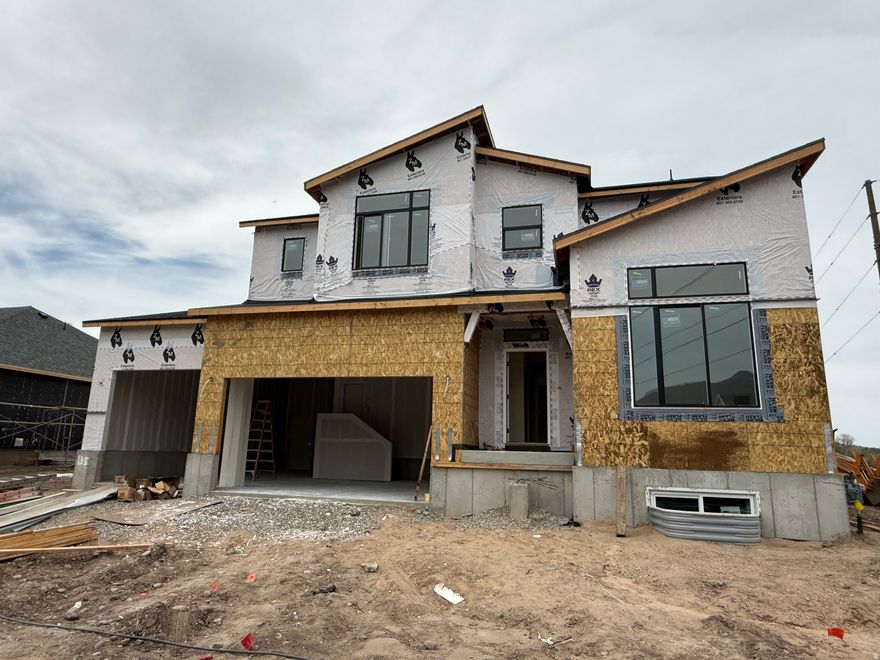 Lock this property down before it's finished! Our Glacier Floor Plan in Riverwood is one you won't want to miss. This beautiful home features 4 bedrooms, 2.5 bathrooms, and a thoughtfully designed layout that offers the perfect space for hosting, gathering, and everyday living. Showcasing one of our newest exterior designs, the Mountain Modern, this home delivers eye-catching curb appeal with a fresh, elevated look. Inside, you'll find spacious living areas ideal for entertaining, along with quality finishes and a layouts. In the kitchen you'll find the quartz countertops, offering both style and durability for daily use. Open-concept living spaces create a warm and inviting atmosphere perfect for everything from quiet nights in to weekend get-togethers. The primary suite serves as a relaxing retreat, featuring double sinks, a separate shower and soaking tub, perfect for unwinding at the end of the day. Additional bedrooms provide flexibility for guests, or a home office. Plus, you'll have a blank canvas in the basement ready to become a home gym, craft room, theater space, or anything your heart desires. Located in the desirable Riverwood community, you'll enjoy convenient access to I-84, Highway 89, and Hill Air Force Base, making commuting and daily errands convenient. Don't miss your chance to secure this beautiful home before construction is complete!