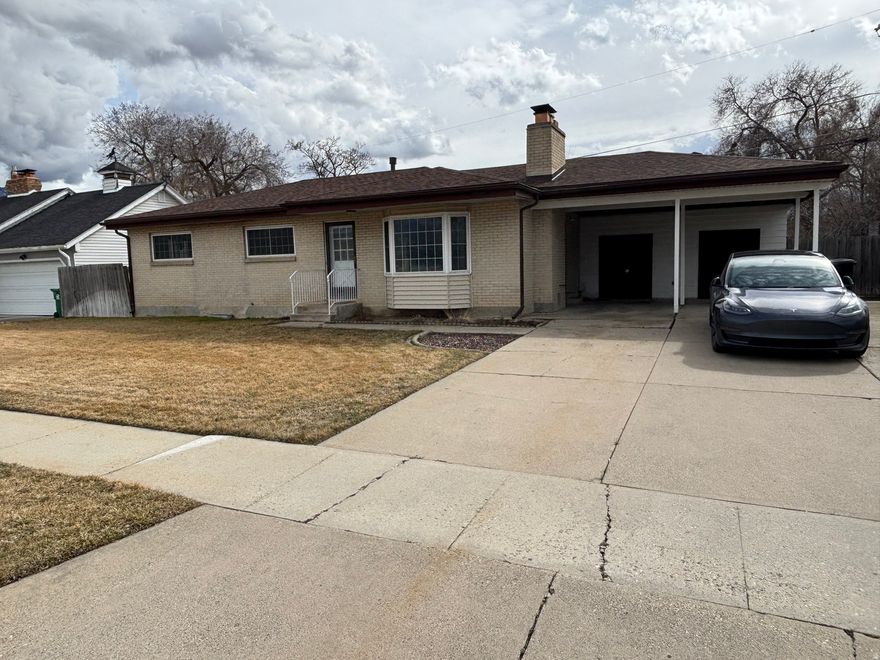 Nice family size rambler in a quiet Millcreek neighborhood. This home has beautiful refinished hardwoods on the main floor. 3 bedrooms up with primary bdrm & 3/4 bath, plus full bath on main floor. Large main floor family rm w/gas fireplace that walks out to a large covered patio and xtra large fenced backyard. Basement has an xtra large family room w/new carpet ,gas fireplace & one bedroom with a 1/2 bath that could easily be converted to a full bath and room to finish another bdrm if needed. Big oversized carport with built in storage that could be enclosed as a garage. Large concrete RV parking next to carport. Newer roof, furnace, A/C. & vinyl windows. New paint and basic updates could easily make this all brick rambler shine.