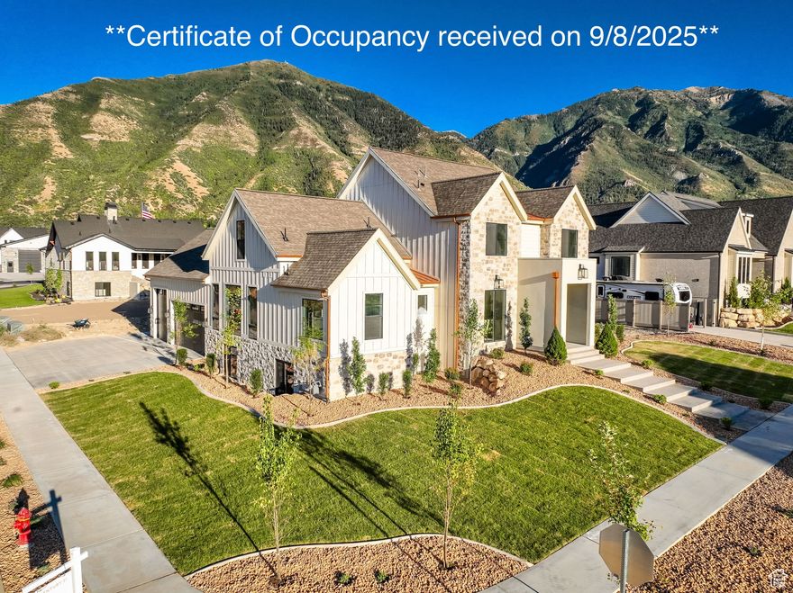 **Certificate of Occupancy received on 9/8/2025** Nestled at the foot of Utah's majestic Wasatch Mountains and situated adjacent to Salem's exclusive, up and coming Three Bridges Resort and Golf Community sits this spectacular luxury residence with breath taking views! Imagine entering the front door into the light and airy open concept space and you won't know what to focus on first...the luxurious chef's kitchen with quartz countertops, top tier appliances, and soft close cabinetry that goes all the way up to your 9' ceilings?! Or the stunning floor to 18' ceiling fireplace in the great room? Or perhaps it's the massive 8' x 12' glass slider that retracts completely to one side and gives way to your awe-inspiring mountain views and indoor/outdoor space?! Whatever it is, this home is a show-stopper, and the impressive finish work and quality of materials doesn't end there. The spacious primary retreat absorbs the entire North side of the main floor and features a large walk-in closet and a well-appointed ensuite bathroom equipped with dual vanity sinks, a euro-glass shower and separate tub! But that's not all...the basement is designed and 100% finished with 9' ceilings, daylight windows (no window wells), a kitchenette, a family room with fireplace, 2 more bedrooms, 1 full bathroom, and a recreation space! Last but not least, be transported away by the uplifting mountain views and the tranquility and peace of the neighborhood yet appreciate its convenient location to many amenities including Costco, Walmart, Cinemark movie theater, schools, freeway access and more.