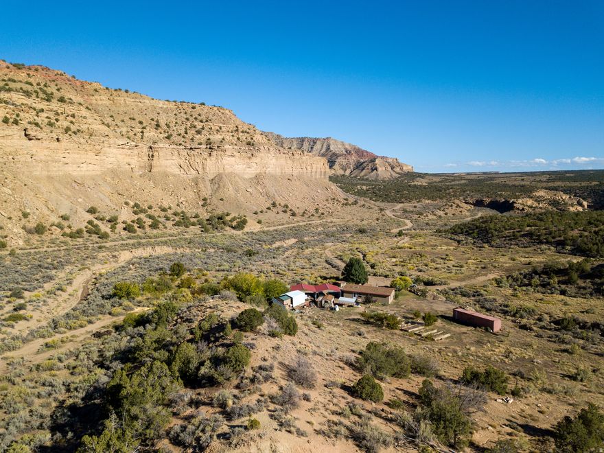 Look no further to realize your country living dream. Seventy scenic acres in Thompson Canyon offer a rare opportunity for self-sufficient living in a quiet, high-desert setting. The land is open and expansive, surrounded by native vegetation and wildlife including deer, pronghorn, bighorn sheep, hummingbirds, and more. Located just beyond the renowned Sego Canyon rock art sites, the property enjoys dark night skies with clear views of the Milky Way and a strong sense of privacy and space.  Senior spring-fed water rights for domestic, irrigation, and stock use support sustainable land use, gardening, and everyday living. Six 4'x16' raised garden beds, peach trees, and a small orchard provide the foundation for a garden-to-table lifestyle. A root cellar allows for cool storage and preservation of harvested produce.  Set on the land is a 1,179 sq. ft. manufactured home built in 2016 on a permanent concrete foundation. The three-bedroom, two-bath home is Energy Star wrapped and designed for efficiency with solar and hydroelectric power systems, propane appliances, and a wood stove and propane wall heater for warmth. Starlink internet supports modern connectivity for remote work or other home-based activities.  Additional improvements include two 24'x24' steel carports, a tool shed, and a solar house-well-suited for off-grid living.  Though peaceful and remote, the property offers access to Moab (42 miles), Green River (31 miles), and Grand Junction (80 miles), with nearby destinations including Arches, Canyonlands, the Colorado River, and Dead Horse Point.  Sale includes Tax ID 04-0020-0071 and 04-0020-0072. Adjacent 20 acres available; see MLS #2062239.