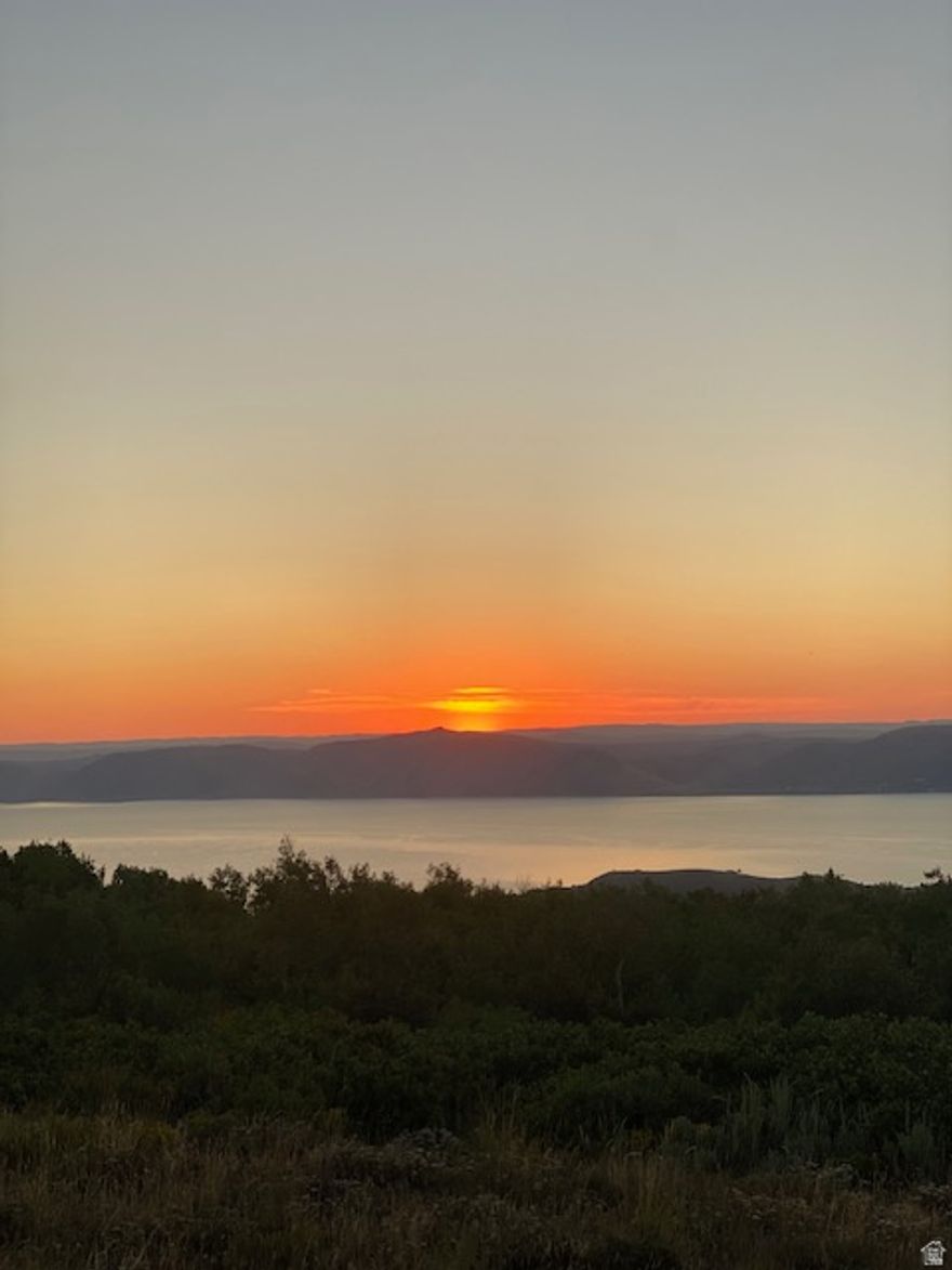 This lot would be an easy build. The view of Bear Lake from your deck at sunrise or sunset would be the highlight of the day, so if you watch both it's double the joy.  You will have the option to buy into Ideal Beach Resort for beach access, tennis court, swimming pool and much more for a annual fee.   Bear Lake is a beautiful vacation destination, buy now and enjoy for a lifetime.