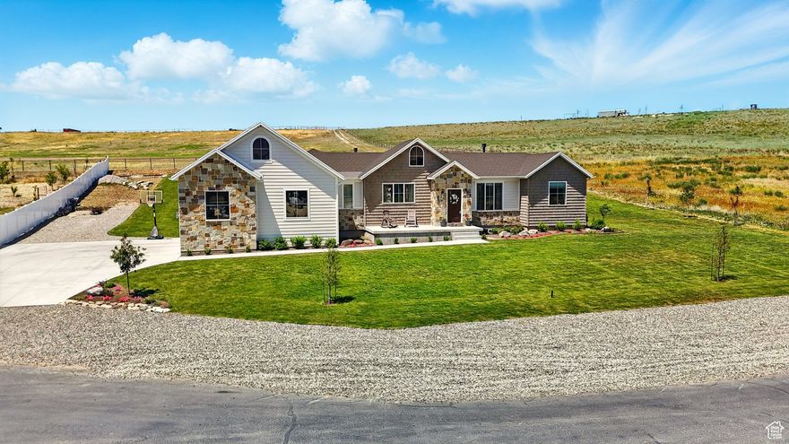 BUYERS FINANCING FAILED - THEIR LOSS YOUR GAIN!   Welcome to this exceptional home in the newly developed Brookside Ranches! Built in 2023 and better than new, this move-in-ready gem perfectly blends modern style with timeless farmhouse charm. Nestled on a beautifully landscaped .75-acre lot-with a fenced backyard, garden spot, and over $60K in professional landscaping-you'll enjoy serene Bear River views to the east. The property is designed for both comfort and convenience, featuring a secondary irrigation well to reduce water costs, an oversized garage, and an extended driveway with plenty of room for RVs and toys. Inside, the inviting open-concept floor plan showcases a cozy brick fireplace, a gourmet kitchen with Quartz countertops, tiled showers, and durable 30-year LVP flooring throughout. Every detail has been thoughtfully crafted, from the spacious mudroom to the walk-in pantry. Curb appeal is just the beginning-this home offers an unfinished basement with endless potential for customization, whether you dream of a home theater, gym, or additional bedrooms. Motivated sellers make this an opportunity you won't want to miss! Buyer to verify all information.