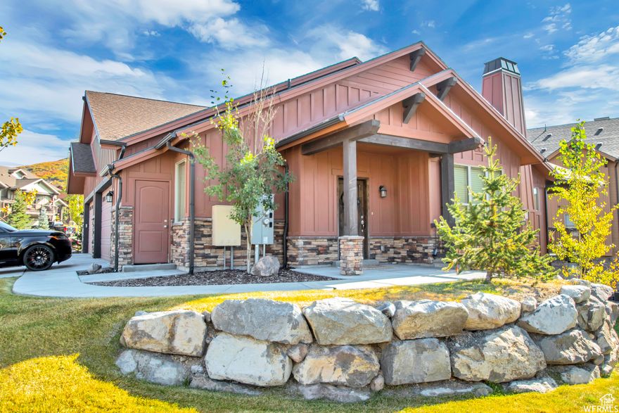 This corner end townhome in Black Rock Ridge offers a refined balance of mountain charm and modern comfort. Designed for connection and retreat with main level living. The main floor welcomes you with an open living room anchored by a cozy fireplace, a dining area for gathering, and a chef's kitchen with a generous island and high end Viking appliances along with a guest powder room. You will also find a private spacious en-suite bedroom with a walk-in closet. You can walk out to enjoy a covered deck with space for a hot tub or firepit inviting year-round mountain living. Downstairs, the home expands into an entertainment haven with a theater room, a second living area with fireplace, and two spacious bedrooms; one en-suite and one near a full guest bath. A second covered patio extends the living space outdoors, creating the perfect spot for morning coffee or evening gatherings. A two car garage, washer and dryer, water softener, and individual thermostats on each level complete the home's features and thoughtful design. Perfectly positioned minutes from Park City, Deer Valley & Deer Valley East Village, Jordanelle, Hideout, and Mayflower, with quick access to Kamas, Heber, and the highway, this home offers a lifestyle of ease where world-class skiing, dining, and adventure are always close to home.  Square footage figures are provided as a courtesy estimate only and were obtained from county records. Buyer is advised to obtain an independent measurement. Buyer and Buyer's Agent to verify all information, which has been provided as a courtesy only. All information is deemed reliable but not guaranteed. Currently offered without furnishings. Home can be negotiated to be sold fully furnished if Buyer desires. Home is scheduled to be staged with all new high end furnishings from HELM.