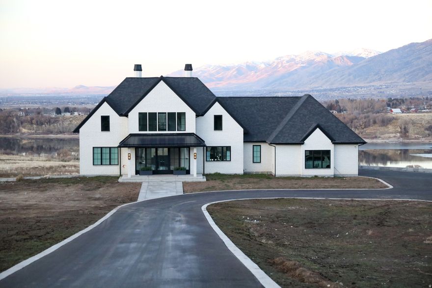 EXECUTIVE HOME ON 12+ ACRES OVERLOOKING HYRUM RESERVOIR WITH UNINTERUPED VIEWS. The finest high end finishes throughout, ceiling to floor windows, Master bed/bath has radiant heated floor, dedicated tankless water heater, and wall to wall marble tile. Marble entryway, solid hardwood on main floor. Heated floors in basement and garage with separate zones. A/C units on each floor. Emtek hardware, soft close drawers and cabinets. Full Vivint camera system, Juke Audio speakers inside and out. Multi slide doors. 64x64 shop with three 14x14 overhead doors, covered RV parking with dump station and electrical hookup. Additional 912 sq ft of storage under garage not included in total square footage. Much much more. Qualified and interested buyers only please.