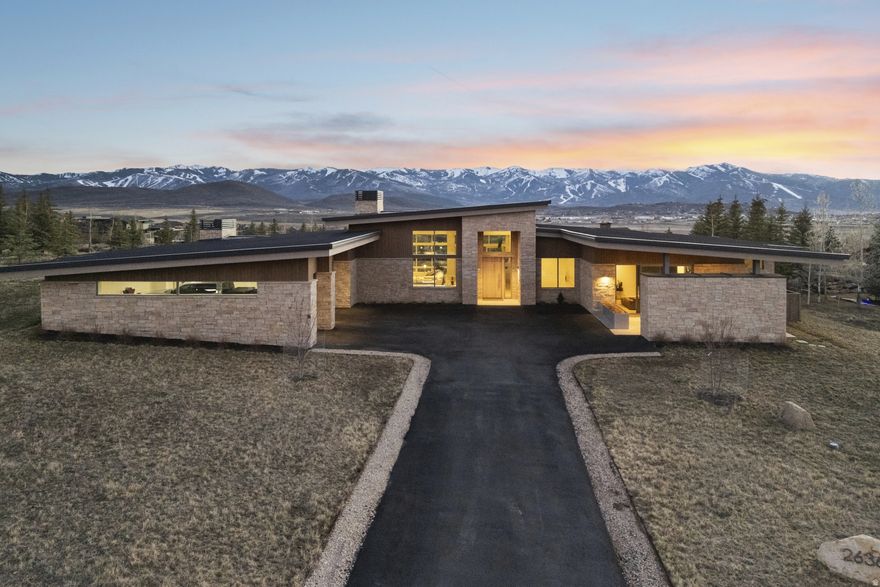 Single-Level Luxury Home in Promontory -- Perched in one of Promontory's most coveted locations, this exceptional mountain contemporary residence captures breathtaking, unobstructed panoramic views stretching from Deer Valley Resort across Park City Mountain-offering a daily backdrop of alpine beauty in every season. Thoughtfully designed for both refined living and effortless entertaining, the home features five spacious ensuite bedrooms, each providing a private retreat with luxurious finishes and serene mountain ambiance. The open-concept great room showcases walls of glass that seamlessly frame the dramatic ski resort vistas, while blending indoor and outdoor living spaces to perfection. A chef's kitchen with premium appliances, custom cabinetry, and elegant stone surfaces anchors the home, complemented by expansive gathering areas ideal for hosting family and guests. Ideally situated just moments from the Equestrian Gate for convenient access in and out of the community, the property also enjoys a premier location within easy walking distance to the Hills Clubhouse. This is a rare opportunity to own a view-driven, luxury retreat in one of Promontory's most desirable settings-where privacy, convenience, and iconic Park City vistas converge.