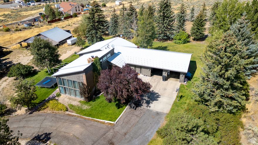 Rare opportunity to own a piece of Wasatch View Acres! Great home offering unique midcentury modern architecture situated on 5 acres with barn and workshop. Approx. 5100 sq feet offering 6 bedrooms, 3 bathrooms, walkout basement, updated kitchen and attached 2 car garage. Many possibilities with this great home and property! Perched above Heber, this great location offers stunning mountain and valley views with easy access to city amenities and schools. 55 minutes to SLC international airport, 40 minutes to Provo/Orem.