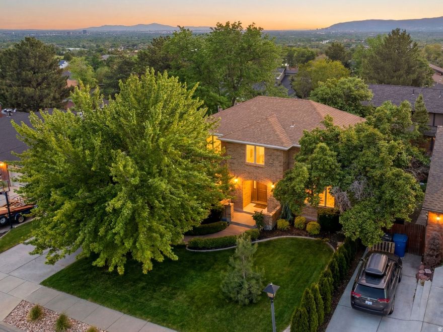 Stunning custom built 2 -Story home situated on a quiet street in one of Cottonwood Heights most desirable neighborhoods. Beautifully updated throughout, this exceptional residence blends modern sophistication with timeless elegance and features a thoughtful open floor plan filled with expansive windows and natural light. At the heart of the home is a gourmet kitchen featuring a large island with bar seating,, a secondary prep sink, ample custom cabinetry, quartz countertops, and premium stainless steel appliances, including a Sub -Zero refrigerator.  Adjacent to the kitchen is a built in side buffet complete with a cocktail refrigerator and ice maker.  The inviting family room with fireplace flows seamlessly from the kitchen, creating an ideal space for cooking, gathering and staying connected. The spacious primary suite offers a large walk-in closet and beautifully appointed bath with double sinks and an oversized shower with a European glass enclosure. Upstairs, the newly updated secondary bath serves two additional bedrooms, while the generously sized laundry room adds everyday convenience. The daylight walkout basement provides substantial additional living space, featuring a large multi-purpose family room with fireplace two additional bedrooms and a newly finished 3/4 bath.  Additional highlights include newly refinished hardwood floors, new carpet, fresh paint, new front porch, a new outdoor patio and a newer HVAC system with 2 furnaces and 2 compressors.  The backyard is a private outdoor oasis with lush landscaping, mature  trees, mountain views, and a flat, usable yard for perfect summer evenings on the upper deck.  Conveniently located near shopping, the freeway and to the mouth of the Big and Little Cottonwood Canyon.  Square footage figures are provided as a courtesy estimate only.  Buyer is advised to obtain an independent measurement.