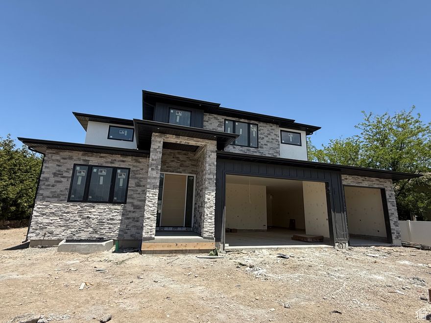 UNDER CONSTRUCTION | ESTIMATED COMPLETION: October 2025  Don't miss your opportunity to own this exceptional custom home in one of South Jordan's most desirable neighborhoods! Currently under construction and thoughtfully designed for both elegance and function, this spacious residence offers 7 bedrooms, 6 bathrooms, and a 4-car garage, making it the perfect sanctuary for modern living.  This home features a private, tree-lined yard, creating a peaceful setting ideal for entertaining or relaxing. Inside, you'll find luxurious finishes and generously sized gathering areas with a seamless flow for hosting and everyday life. The open floor plan is highlighted by two main floor offices, perfect for working or learning from home.  The deluxe accessory dwelling unit (ADU) is an incredible bonus, offering full functionality for multigenerational living or income potential, complete with its own separate access and stylish design.  Additional highlights include:  A dedicated exercise room, a rec room with a wet bar and theater space for ultimate entertainment, high-end finishes and custom details throughout, and mature trees providing privacy and natural beauty.  This home has been expertly designed for both luxury and everyday convenience.