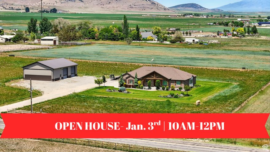 Welcome to this beautiful rustic country estate in the quaint town of Portage, Utah. Nestled on over 6 acres and surrounded by sweeping valley views and mountains, this 4656 sq. ft. ranch-style rambler was built with quality, comfort, and timeless design in mind. Inside, you'll find 4 spacious bedrooms, 4 bathrooms, and main-level living with an open floor plan featuring vaulted ceilings, wood flooring throughout, and three cozy gas fireplaces. The fully finished basement includes a private garage entrance, ideal for guests or extended family. A large laundry room with custom cabinetry and an oversized 3-car garage-equipped with hot/cold water and a utility sink-make everyday living both functional and convenient. Craftsmanship and efficiency were top priorities, with extra insulation, a whole-house ventilation system with heat exchanger, dual furnaces and water heaters, and two 1,000-gallon buried propane tanks. Both the home and the shop are supported by their own septic systems. Outdoor living is equally impressive. Relax on the covered patio with a gas fireplace, plumbed for a hot tub and perfect for summer picnics, while enjoying western sunsets and the property's 3-rail concrete fencing. A true standout is the 45x60 heated and fully insulated shop/airplane hangar-complete with a 40x14 hangar door, two 12x14 shop doors, 220 power, RV hookups, an indoor bathroom, and full exterior lighting. As an added opportunity, with a 2-acre minimum building requirement, the western pasture offers the potential to create an additional building lot with 200 ft. frontage (available only after the home has sold). This home has been immaculately cared for, built to last, and comes with TVs, state-of-the-art sound equipment, and a 12-month home warranty. Shown to qualified buyers by appointment only. Buyers to verify all information.