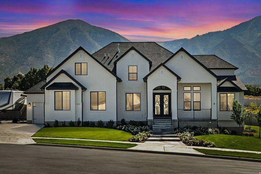 JUST LISTED! Come for the views-stay for the extras! Nestled in a quiet double cul-de-sac at the base of the Nebo Mountain Range, this French provincial-style home has it all: stunning mountain views, a large, manicured lot, an extra 3rd car garage, a huge RV pad, a winter greenhouse, a putting green, a 15 ft. waterfall, and an observation deck to enjoy it all. The interior features a 2-story great room with XL windows to capture the mountain and waterfall views. The master bedroom boasts 14 ft. ceilings and two large walk-in closets (his + hers) with stackable W/D and double vanities in the grand master bath. Also on the main floor are a spacious, private office, a second office or craft room, and a walk-in pantry in the bright, open kitchen. Upstairs, you'll find 3 bedrooms, a full bath, and a second laundry setup. In the unfinished basement, there's space for 3 more bedrooms, a full bath, and a large family room. Sellers finished an attic room to use as a sauna + yoga room, but it could also serve as an office, additional storage, or a home gym. Come see this beautiful home for yourself!     ( *More pics of master bath, second walk-in closet, and finished attic room coming soon* )