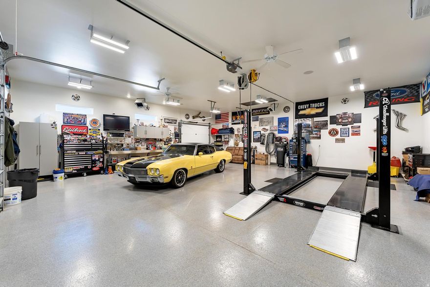 Imagine coming home to space, comfort, and freedom-1.11 acres designed for living well, playing hard, and enjoying every season. This beautifully cared-for property blends country calm with city convenience, creating a setting where everyday life feels like a retreat.  Inside, soaring vaulted ceilings and a striking floor-to-ceiling fireplace set the tone for cozy evenings and effortless entertaining. The gorgeous custom kitchen will wow you with its thoughtful design. Natural light fills the home, while thoughtful upgrades-owned solar, a whole-house fan, plantation shutters, and LED lighting-add comfort, efficiency, and ease.  Step outside and your lifestyle truly expands. A wrap-around Trex deck invites morning coffee, sunset dinners, and weekend gatherings. The fully fenced yard offers room to roam, play, garden, or relax beneath the gazebo, while garden boxes, irrigation, and open green space make outdoor living simple and rewarding. There's space for laughter, playsets, pets, and quiet moments alike.  For hobbyists, car enthusiasts, or anyone who loves a well-designed workspace, the garages are a dream come true. The finished 34' x 34' rear garage is more than storage-it's a personal retreat with heating, epoxy floors, premium cabinetry, sound system, and room to create, build, or unwind. The front garage and covered canopy add even more flexibility for toys, tools, and projects.  This is a home built for people who value space, craftsmanship, and lifestyle-a place where memories are made, passions are pursued, and pride of ownership is felt in every detail.