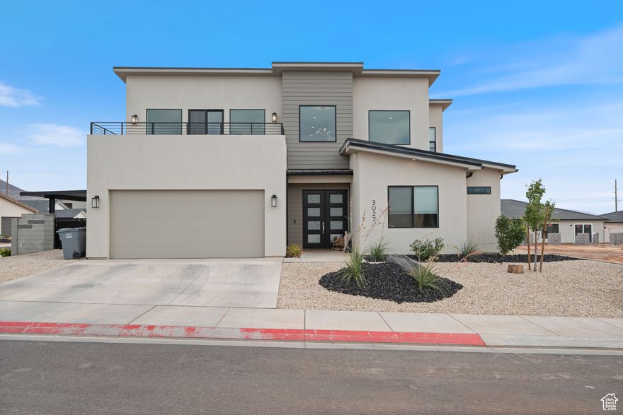 Nestled just minutes from St. George, this stunning 2-story home offers the perfect blend of peaceful living and convenience. The well-designed layout includes a spacious bonus family room upstairs - ideal for relaxing or entertaining. Step outside to enjoy two decks: one covered for shade and one open for sunbathing, both boasting breathtaking views of Pine Valley, Kolob, Sand Hollow, and the dunes. The custom kitchen features beautiful cabinetry with matching shelves in the family room for a cohesive, high-end look. The large two-car garage is equipped with an insulated door, weather trimming, a mini-split system, and Tesla charging. An attached covered patio offers extra space for toys, bikes, ATVs, or side-by-sides, plus RV hookups - perfect for adventure lovers. With easy access to scenic walking trails and just a short drive into the center of town, this home is a rare find that combines comfort, views, and functionality.