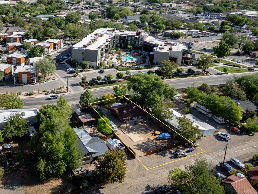 Positioned in the heart of Moab on Center Street, this C-2 Commercial Residential property offers a rare blend of flexibility, location, and future upside. Situated on a 0.24-acre lot with paved access and ample on-site parking, the property is ideally suited for a wide range of permitted uses including residential, office, or mixed-use applications.  The existing single-level home has been substantially improved, with an effective build year of 2010 reflecting updated electrical, new panel, tile flooring, insulation, and window replacements. The current layout includes two bedrooms, one bathroom, a functional kitchen and living area, and a bright solarium space, making it immediately usable for residential occupancy or adaptable for professional or service-based commercial use.  The fully fenced lot, gravel parking area, and strong street frontage provide both privacy and usability, while the flat terrain and surrounding red rock and mountain views enhance the setting. Utilities are fully connected, and the property includes a metal roof, basement storage with radon mitigation system, and a combination of heating and cooling options for year-round functionality.  Located within Moab's C-2 zone, the property presents a compelling opportunity for investors, business owners, or those seeking a live/work configuration in a high-demand corridor. With proximity to downtown amenities, steady traffic exposure, and zoning that supports both residential and commercial integration, this property is well-positioned for long-term value and strategic redevelopment.