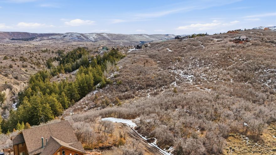 3.47 Acres with Septic Approval + Engineering Completed  Build with confidence on this exceptional 3.47-acre corner hillside lot - one of the largest parcels in the subdivision. This property comes with much of the groundwork already completed, including:   Passing perc test   Topographic survey   Approved septic design for up to an 8-bedroom home Engineered home plans are also available (negotiable separately), offering a head start for buyers ready to move forward. Tucked into a private corner setting, the lot offers year-round access and an ideal location for either a full-time residence or mountain retreat. Enjoy the peaceful surroundings while remaining just minutes from the amenities of Heber Valley and Park City. Outdoor recreation is truly at your doorstep - hiking, ATV trails, world-class skiing, snowmobiling, fishing, and golf are all nearby. A rare opportunity to secure one of the subdivision's premier lots with key approvals already in place. Acreage measurement given by county records.