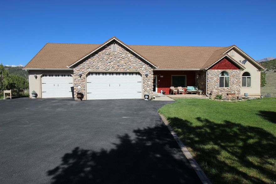 Elegant home with 6 bedrooms, office, 3 baths, 2 family rooms and gorgeous kitchen!  Loaded with extras including upgraded carpets, hardwood floors, jetted tub, 2 gas fireplaces plus a wood burning stove, vaulted ceilings, large laundry room with sink and folding counter, 24'  Trex Deck.   Spacious dining area with wonderful valley views! 3  garage on the main level plus another 2-3 car garage below (32' deep plus an adjoining 15' x 25' storage room).  This could all be a  Huge workshop area!!   BRING YOUR HORSES - a nice corral is already built!  Wonderful 1 Acre Lot with lots of seclusion next to a large common area.  2" x 6" construction and  protected by a Fire-Sprinkler System. Enjoy Country Living at its best!  Only a short 25 minute drive to Spanish Fork - it's not that far to town.   Square footage figures are provided as a courtesy estimate only and were obtained from Utah County.  Buyer is advised to obtain an independent measurement.