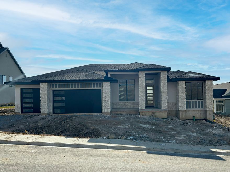 LOT#107. Come see the difference from Symphony Homes, a renowned local builder of semi custom homes! New luxury neighborhood of Blossom Hill, perfectly located in Pleasant Grove. Great looking rambler, the Tempo plan with our modern Prairie exterior. Many upgrades throughout and classy interior design and finishes! Decorative wall in flex room off of entry, LVP floors and stunning grid bean ceiling in the family room. Galley kitchen with oversized island bar, butler's pantry, and dining nook. Owner's suite has a recessed ceiling with beams, free standing tub, oversized shower with Euro glass and the walk-in closet is finished with custom built-ins. 2nd bedroom on main level has its own ensuite bathroom! Dedicated laundry room with a countertop. You'll love entertaining in the finished basement with family room/game room and attractive wet bar, along with cold storage and a finished storage closet. 21'-2" X 18' L-Shaped covered patio, and lots of storage space throughout. Equipped with active radon system. Full yard landscaping is included in price and is currently in progress. Don't miss this one! This home will be completed in April of 2026.