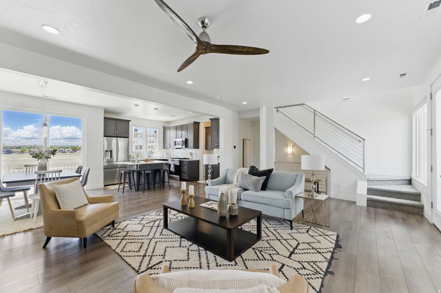 Welcome Home to the Heart of Daybreak! This stylish townhome offers the perfect blend of modern convenience and comfortable living in an unbeatable location. You'll be at the center of it all, just minutes from Trax, Oquirrh Lake, the upcoming Downtown Daybreak featuring Megaplex movie cinema, and the new Salt Lake Bees Stadium. You'll be at the center of it all. Inside, you'll love the open-concept floor plan filled with natural light from large windows. With three spacious bedrooms and thoughtful design throughout, there's plenty of room to live, work, and relax. Enjoy two private balconies-ideal for entertaining, unwinding, or simply taking in the scenic views. The extra-deep two-car garage features a built-in workspace or separate storage area, and the fenced front yard boasts low-maintenance landscaping for easy outdoor living. With modern finishes, a smart layout, and a location that puts everything at your fingertips.