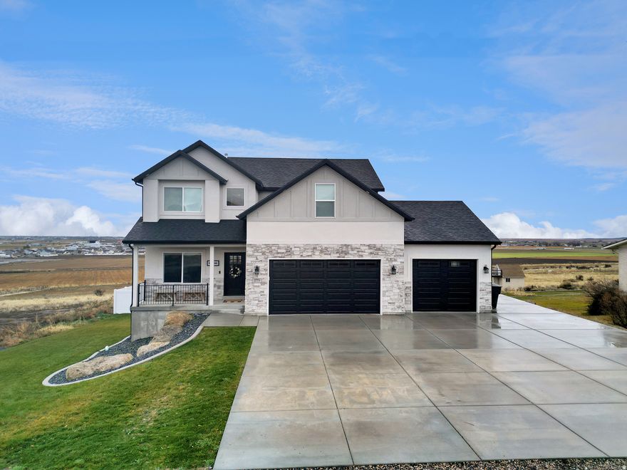 ***MOTIVATED SELLERS & Huge price improvement*** Welcome to this stunning, like-new home built in 2023 on a large lot with truly unobstructed views stretching from farmland to the mountains and clear sightline all the way to Salt Lake City. This home features beautiful, modern finishes, including a bright open-concept layout designed for everyday living and entertaining. The kitchen has beautiful granite countertops, a large island and a walk-in pantry. There are also two furnaces for extra efficiency. The living room features a beautiful stone fireplace with custom built-ins and open shelving. This home offers the perfect balance of comfort , space, scenery and quick freeway access. There is also an RV pad for additional parking. Don't miss this rare opportunity to own a view property that truly delivers inside and out!