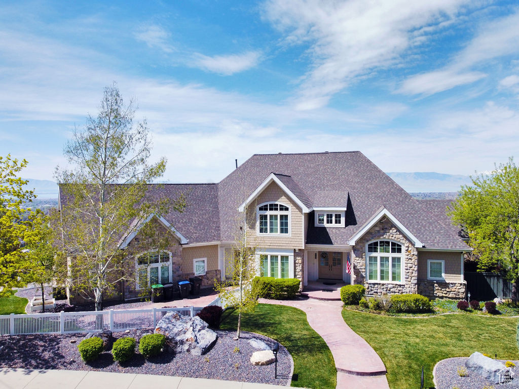 ESTATE LIVING WITH PANORAMIC MOUNTAIN AND VALLEY VIEWS. Perched on the East Bench of Provo at the  foot of Y Mountain in the sought-after Oak Hills neighborhood, this former Utah Valley Parade of Homes  custom home offers sweeping views of the Wasatch Mountains, Utah Lake, and Utah Valley. The perfect blend of comfort and sophistication, this coveted location is conveniently close to downtown, BYU campus, and the scenic Provo Canyon.  DISTINCTIVE FEATURES AND AMENITES. This beautiful designed home welcomes you with a grand entry and soaring ceilings that create an immediate sense of space and elegance. The open floor plan seamlessly connects the formal living areas with the gourmet kitchen, featuring granite countertops, stainless steel appliances, and a huge kitchen island perfect for family gatherings or entertaining guests.  The massive kitchen pantry offers plenty of storage for all your culinary needs. The main level primary suite offers a peaceful retreat with large windows capturing valley views an ensuite bathroom featuring a large tub, and a generous walk-in closet with convenient laundry hookups. BACKYARD Step outside  to over a half acres of untapped potential waiting for your personal touch. This expansive yard is a blank canvas ready for your landscaping vision, whether  you dream of creating entertainment spaces, gardens, or play areas for the family. There is also a gated driveway for added privacy and security. A fully-designed landscaping plan is available  upon request ADDITIONAL HIGHLIGHTS *Brand new roof, replaced in Dec 2024 * New AC and Furnace, ensuring year round comfort * Spacious 3-car garage on the main level, plus a lower garage with additional storage space  *Fully finished basement featuring a complete mother-in-law apartment with a separate laundry and full kitchen * New carpet and fresh paint downstairs *Hardwood floors throughout main living areas * Custom built-ins and architectural details *Rachio Smart sprinkler boxes for efficient water management *Exercise room, perfect for your fitness routine *Bunk room, ideal for sleepovers or hosting guests *Office space for your work-from-home needs * Book nook for reading or displaying your collection *Central vacuum system for easy cleaning *Security cameras and a comprehensive security system for your peace of mind *Easy access to the Y-Trailhead, Bonneville Shoreline Trail, and minutes from additional hiking trails, shopping, and dining *Walking distance to the newly constructed Wasatch Elementary School District . *Access to Google Fiber's Gigabit Fiber Optic Internet, with lightning-fast speeds up to 8 Gbps.  This exceptional home combines  premium craftsmanship with a prime location, offering an unparalleled living experience in one of Provo's most desirable neighborhoods. Don't miss this opportunity to make this remarkable property your own.