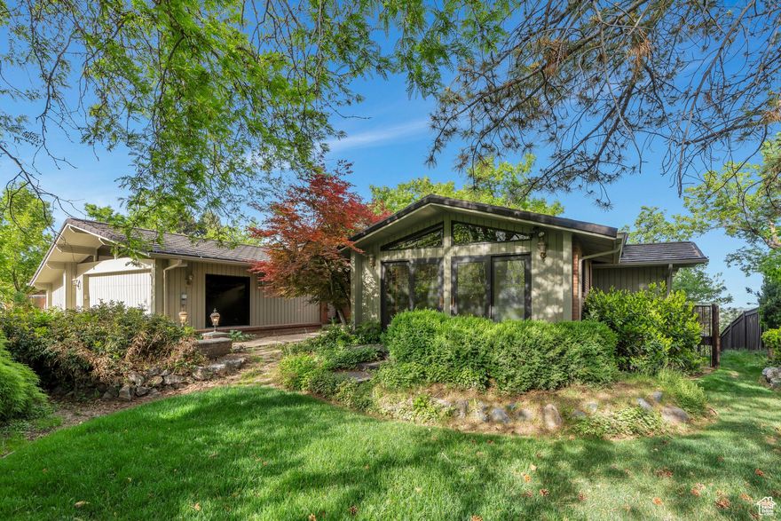 Located in the highly desirable Indian Hills neighborhood in East Provo, just minutes from BYU, Timpview High, and Provo Canyon, this spacious 5-bedroom home with incredible views of the lake and valley is up for sale.  It features many upgrades, including vaulted ceilings with wood beams, floor-to-ceiling windows, custom marble tile, cherry wood floors & custom cabinetry throughout the home and a grand fireplace. Main floor living with upgraded kitchen opens to a large dining space and family room with custom shelves.  The master suite has a walk-in closet and bathroom with granite countertops.  Charming office with built-in bookshelves and cabinetry that opens to its own private patio.  Large walkout basement with plenty of room to entertain.  Gorgeous outdoor spaces with large mature trees, patios, and stunning views of Utah County & Timpview High fields.