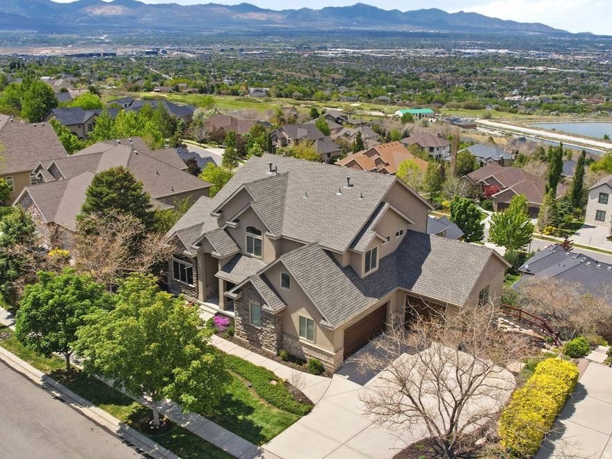 This stunning 6-bedroom, 3 full bathrooms, two 1/2 bathrooms single-family home offers a spacious 5356 sq.ft of pure elegance and comfort. Imagine waking up every morning to breathtaking views of the Salt Lake Valley, with the sun painting the sky as you enjoy your breakfast next to a tranquil pond water feature in your private outdoor oasis. Step inside and experience the ultimate in luxurious living. Two full kitchens await those who love to entertain offering endless possibilities for hosting everything from intimate family dinners to lively gatherings with friends. Each space is thoughtfully designed with high-end finishes that will make your culinary adventures a joy.  Nature lovers will rejoice in the unbeatable access to nearby hiking and biking trials, perfect for those who love outdoor adventures. And let's not forget the fully landscaped yard, which make this property a true retreat from the everyday hustle. Whether you're unwinding on a quiet evening or savoring spectacular sunsets over the valley, this home feels like a permanent vacation spot.  Located in a community that offers serene hiking trails, you'll find peace and relaxation at every turn. Plus, you're just moments away from local dining and shopping hotspots, ensuring convenience is always at your fingertips. Homes like this, with its unique blend of nature and luxury, are rare and highly sought after. Don't wait. Schedule your private tour today and see why this remarkable property should be your forever home! Square footage figures are provided as a courtesy estimate only and were obtained from county records. Buyer is advised to obtain an independent measurement.