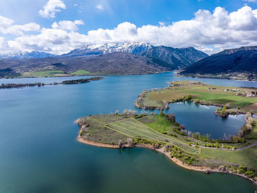 Opportunities like this don't come around twice. Nestled within an exclusive gated community in the heart of Eden, Utah, this stunning 5-acre parcel sits on the water's edge with unobstructed views of Pineview Reservoir and the iconic slopes of Snowbasin Ski Resort. The aerial says it all, this is one of the most visually striking building sites in the entire Ogden Valley. Flat, buildable, and primed for a world-class custom home, this lot offers the kind of privacy and setting that luxury buyers spend years searching for. Whether you're envisioning a modern mountain masterpiece or a refined Utah lodge, the canvas here is as good as it gets. Design around panoramic lake views from every room, watch the sunrise paint the Wasatch peaks from your back porch, and ski three resorts, Snowbasin, Powder Mountain, and Nordic Valley - all within minutes from your front gate. The gated entry ensures the privacy and security that discerning buyers demand, while the flat topography keeps build costs clean and maximizes your design flexibility. Five acres of elbow room means your estate truly feels like an estate. Eden is no secret to those who know, it's Utah's best-kept luxury address. Year-round outdoor recreation, mountain scenery that rivals anything in the West, and a setting that simply cannot be replicated. This is the lot you build your legacy on.