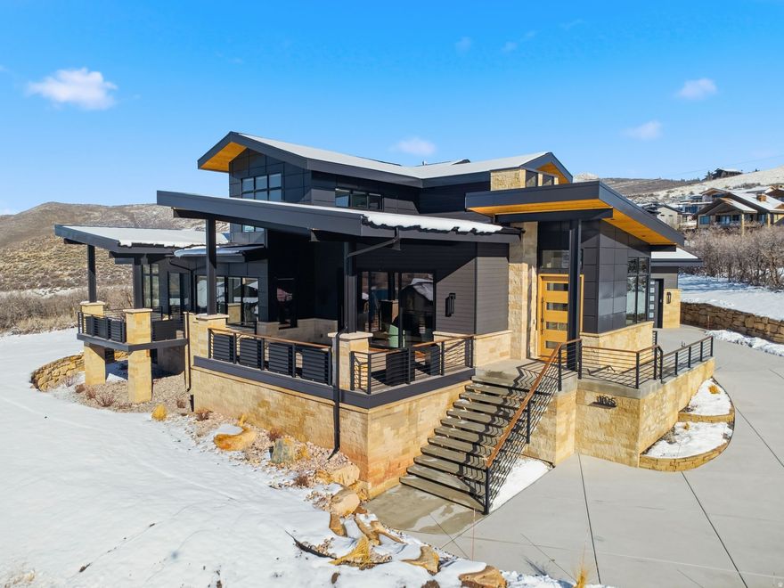 Enjoy elevated living in this stunning Hideout retreat perched above the Jordanelle with sweeping views of Deer Valley and Timpanogos. This custom mountain contemporary masterpiece blends luxury with lifestyle. Newly completed construction stretches over 6,000sf of mindfully designed, beautifully furnished living space, where every window frames a postcard view. The open floor plan flows effortlessly from a professional-grade kitchen complete with wine fridge, oversized island, and dining area to the heart of the home, a light-filled great room with fireplace leading to an expansive deck made for morning coffee or sunset gatherings. The main-level primary suite delivers easy single-level living, while a dedicated office with dual workstations keeps productivity within easy reach. Downstairs, entertainment takes center stage in the family room, complete with wet bar and game area or you can relax in the sauna after a day on the slopes or nearby golf course. A separate flex space would be perfect for movie night or home gym. With 5 bedrooms and 7 bathrooms, there's plenty of space for everyone to unwind. Downstairs your guests can enjoy a large ensuite bedroom and a well-designed bunkroom that sleeps 6 with separate bathroom. Upstairs features a beautiful sitting room with glorious views and 2 additional ensuite bedrooms. Step outside to enjoy a hot tub soak in a private, landscaped outdoor living space. Crafted with a modern mix of stone, wood, and metal, this home celebrates Hideout's natural surroundings while offering the comfort of central A/C, 3 furnaces, and a 3-car garage for all your mountain toys. Just 12 minutes to Deer Valley East Village, 17 minutes to Park City's Main Street, and 45 minutes to Salt Lake Airport, Utah's best recreation, including skiing golf, mountain biking, boating, and fishing on the Jordanelle will be at your doorstep. Here, every detail reflects the art of living well... elevated, effortless, and just a little bit adventurous.