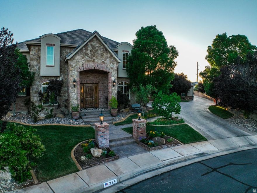 Located in the highly sought-after Heritage Estates neighborhood, this custom-built luxury home offers 6,319 sq. ft. of living space plus 728 sq. ft. of storage. With NO HOA, stunning views of Red Mountain, and a large backyard designed for entertaining, this property combines quality craftsmanship, space, and comfort in one of Southern Utah's premier neighborhoods. The curb appeal immediately stands out with elegant carriage-style garage and a beautifully maintained exterior. Inside, the main level features a welcoming seating room near the front entry, a private office to the left, and a formal dining room to the right. The spacious family room sits next to the kitchen and provides the perfect setting for gatherings and entertaining The gourmet kitchen was designed with both everyday living and hosting in mind. It includes double dishwashers, generous counter space, and a large hidden pantry. The main-level primary suite offers a peaceful private retreat, complete with two walk-in closets and a stack washer and dryer built into one of the closets for added convenience. Upstairs includes additional bedrooms and bathrooms, another comfortable gathering area, and a full laundry room. The basement adds even more functional living space with a theater room, oversized craft room, family/game room with wet bar, and a full bathroom. There are also two storage rooms with concrete door frames that could easily be converted into secure storage or luxury safe rooms. Step outside and enjoy resort-style living in the massive backyard featuring a pool, firepit area, gardens, horseshoe pit, and a full pull-around driveway behind the garage for extra vehicles, trailers, or recreational toys. The oversized 3-car garage also includes a separate exterior-access storage room for lawn equipment and tools. This exceptional property offers luxury, privacy, and space in one of Southern Utah's most desirable locations. Homes of this caliber in Heritage Estates rarely become available.