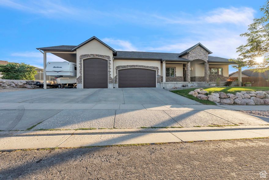 Stunning Custom Rambler on Tooele's East Bench! This amazing and unique 5-bedroom, 3-bathroom home on the East Bench of Tooele offers a rare blend of comfort, functionality, and luxury upgrades. With over 3,872 sq. ft. of finished living space, this property is designed for both everyday living and entertaining.   3-Car Garage + Extra-Long 3rd Bay  Includes covered RV parking, storage loft, and a 500 lb electric winch for heavy items  Heated Concrete Driveway  Snow removal made simple for Utah winters  Whole-House Radiant Heated Floors  Exceptional comfort year-round  Chef's Kitchen  Granite countertops, pot filler, large island, window cabinetry, stainless steel appliances, and two separate sink areas  Primary Suite Retreat  Walkout deck, radiant-heated bath floors, dual vanities, marble countertops, oversized walk-in shower with dual shower heads, and walk-in closet  Fully Finished Basement  Perfect for entertaining and gatherings  Backyard Oasis  Professionally landscaped with a firepit area  Attic Furnace & Water Shut-Off by Room  Added efficiency and peace of mind With thoughtful upgrades like a 31-ft garage depth, instant hot water system, and abundant storage throughout, this home delivers the ideal balance of luxury and practicality. Located in the sought-after Tooele Heights community, it offers mountain and valley views, paved sidewalks, and quick access to schools, shopping, and dining.