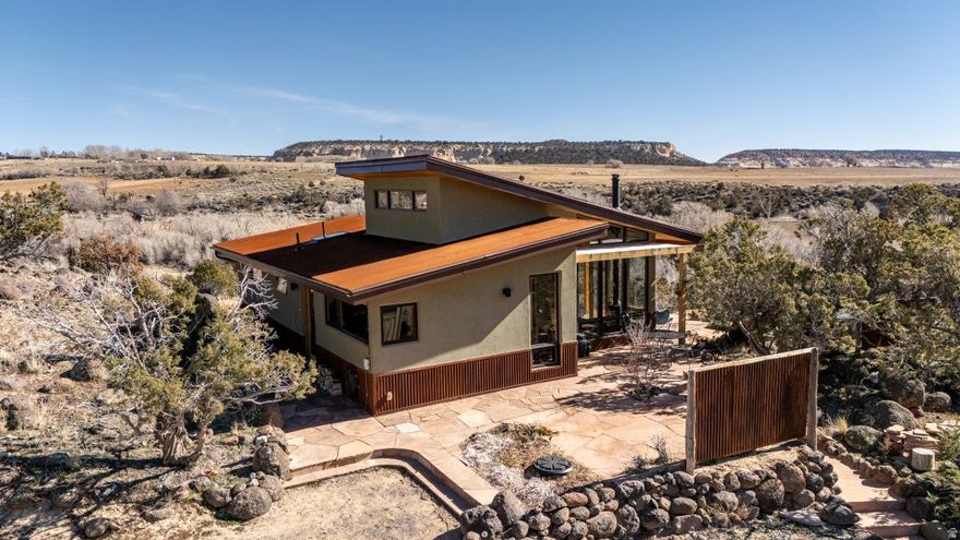 Very appealing contemporay home on 1 acre hilltop in Boulder. Contemporary one bedroom with sleeping loft, Extremely well designed and well built. Stucco and metal exterior with useful overhangs. Very creative, tasteful and excellent use of space. Many windows perfectly placed for light and view. Mini-splits for heating and cooling in addition to wall heaters and a wood stove. Wonderful outdoor living areas with stone patios and paths to take in the fabulous views. Includes a workshop/studio as well as an historic Boulder building. Landscaped with trees and native plants. An enjoyable spot!