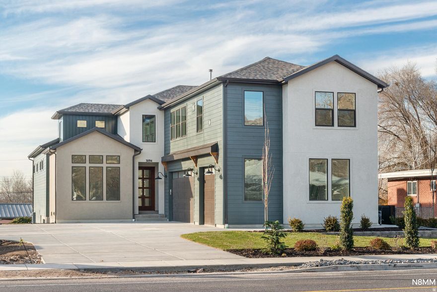 Experience refined modern living in this professionally designed Millcreek residence, where every element has been intentionally crafted for style, comfort, and longevity. Sleek metal-seam exterior accents complement the home's elevated interior finishes, while oversized windows and custom design details create naturally bright, welcoming spaces throughout.  A rare integrated ADU with a private entrance and lock-off flexibility provides premium versatility-ideal for extended living, guests, or a dedicated work suite. The spacious, open layout offers effortless flow for both everyday living and entertaining, with thoughtfully planned gathering areas on each level.  Situated in a prime Millcreek location with no HOA, this home blends luxury, function, and modern architectural appeal in a way that stands out at every turn.