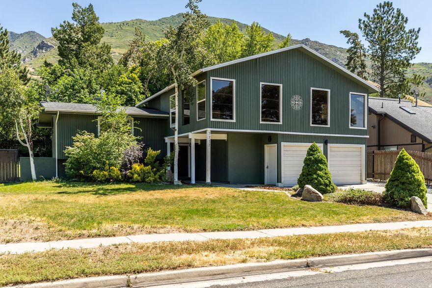 Sitting at the base of both Cottonwood Canyons, this charming home encapsulates the value of its proximity to outdoor adventure. Only minutes from Brighton, Solitude, Snowbird, and Alta mountain resorts. This corner lot has a large secluded backyard with a newly built deck. Inside, you'll find hardwood floors, vaulted ceilings, and beautiful light. The five bedrooms are on three different floors, allowing for plenty of options to make this house work for your wants and needs. The kitchen is right off from the deck, enjoys plenty of light, and is open and welcoming. The primary bedroom is on its own floor with an en suite bathroom. There is an RV parking pad as well as a two car garage.