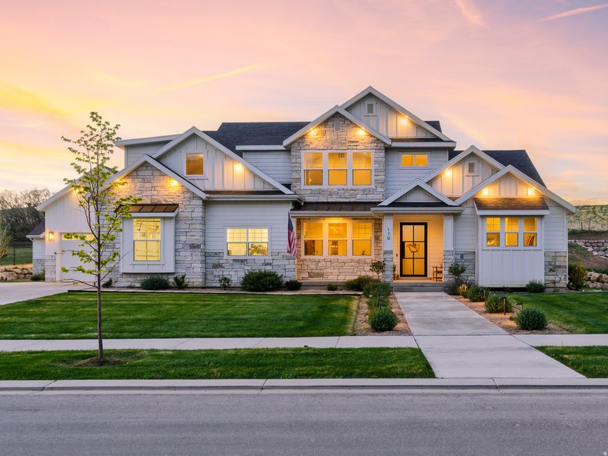 A home with 9,930 square feet on 0.65 acres, built in 2022, backed by views of the Wasatch Front. The two-story great room runs wide-plank white oak flooring and a full-height shiplap fireplace. The kitchen has a 6-burner range, double ovens, a custom plaster hood, and a second prep island. The primary bath includes a freestanding tub and dual vanities. The 6,725 SF finished walkout basement is where this home separates itself. A dedicated theater with graphite panel-molding walls, a home gym with rubber flooring, a wet bar, and a full indoor sport court with basketball hoop and pickleball net with clerestory windows overhead. Outside, a covered upper deck, covered patio, fire pit, and tiered boulder hardscape step into the hillside. Four-car garage with EV charging.  Twin Hollow is a quiet, established Mapleton neighborhood where families come and put down roots. Trails for biking and walking just minutes away and provides Utah County access without the Utah County density. No HOA. Matterport 3D tour available upon request.