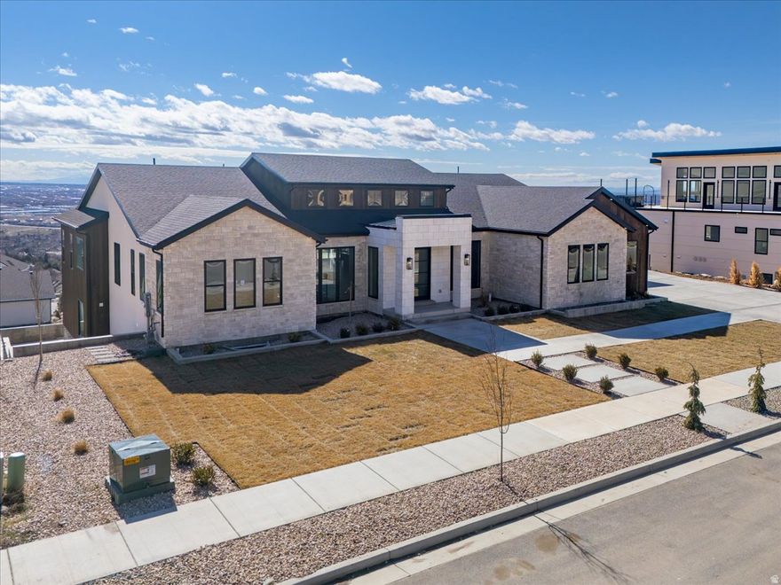 Stunning custom home located in Pleasant View on the mountain side with incredible views. This home has everything 2 master suites on the main level, Custom staircase , Huge fireplace and front room living area with large windows looking out over the valley, very unique island design 2 prep islands one with a sink ,large island seating , huge double sink built in to the countertop with a double faucet . Downstairs has a huge entertaining area with a kitchen with custom candy drawers , Large theatre room extra laundry room , full gym with a garage door that opens out to the patio. Builder will bring in fill dirt for the built in planter boxes out back, pool can be added for additional cost.