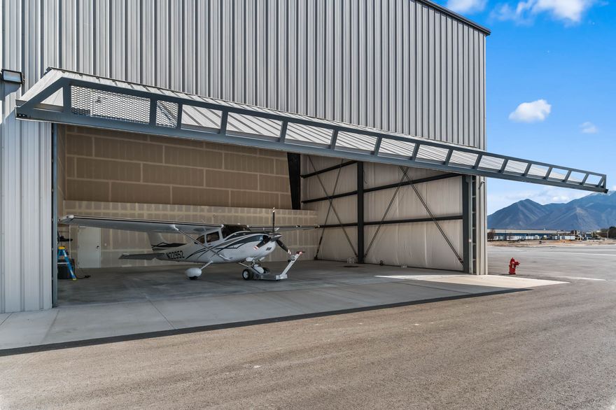 Unit D14 at Patey Aviation Park North - south end-cap on the east wing of Building D at Spanish Fork Municipal Airport (KSPK), a public-use general aviation airport in the heart of Utah Valley. This 48x42 hangar delivers a full-width 43' hydraulic door with 16' clear height and 23' eave, giving you room to work around most single-engine aircraft and many light twins without compromise. Direct taxilane access straight to the runway. No repositioning. No workarounds. Wheel out and go. What makes D14 rare is the position. South end of the wing with only one shared wall and buildable space to the south beyond the current building footprint. An owner can expand into a private lounge, office, workshop, or full amenity build-out without eating into hangar floor space. That option does not exist in mid-row units. For a pilot who wants a hangar that grows with them - not one they outgrow - this is the unit that makes it possible. The building delivers three-phase power to the infrastructure with 200-amp single-phase service to each unit, with three-phase upgrade available. 23' eave height. 16' door clear height. Move-in ready. Building D includes a shared pilot lounge, restrooms, and common amenity space. Fuel on field - 100LL and Jet A - with a dedicated Patey north-side fueling facility planned. Aircraft maintenance available on field. Based aircraft receive one complimentary landing per day. Airport elevation 4,529 MSL. 6,500' lighted asphalt runway. AWOS 119.275. CTAF 122.9. Ground lease 50 years at ~$0.45/sf/year. Utilities paid by owner. $430,511 | HOA $165/mo | 2,016 SF | 48x42 | 43' Hydraulic Door | 16' Door Clear | 23' Eave | KSPK Direct Taxilane | End Unit - Expandable South | Move-In Ready