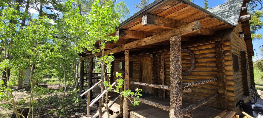 Cabin located within Pines and Quaking Aspens. This is an historic off-grid cabin. Includes your classic outdoor enclosed out house and open sky shower. All furniture included. Land is flat around Cabin roughly 4 acres with a circular driveway for trailer. Northwest section of lot has a location for water providing a down slope pressure to Cabin. Cabin with 2 bedrooms main... upper loft... outlets for lighting with generator power... 1905 antique stove for heating and cooking... classic country railings. New flooring on Main. All furniture included. Small personal items go. Buyer to verify all information. Cabin sold as-is.
