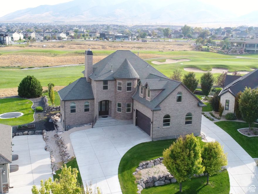 Stunning Custom-Built Home sitting on hole #18 of Talon's Cove Golf Course! Beautifully designed 4-bedroom, 3.5-bathroom home offers luxurious living with timeless craftsmanship and premium upgrades throughout. This residence welcomes you with a serene wall water feature and breathtaking mountain and lake views.  Step inside to find rich Malaysian architectural hardwood floors, elegant crown molding, an upgraded kitchen featuring walnut cabinets, granite countertops and bay window seat that adds charm and functionality.  Retreat to the expansive master suite, complete with his and hers walk-in closets and a spa-like bathroom with travertine tile.  The spacious theater room with a wet bar is perfect for entertaining, every detail in this home has been carefully curated, offering both beauty and comfort in every corner. Don't miss the chance to own this one-of-a-kind masterpiece in an unbeatable location!