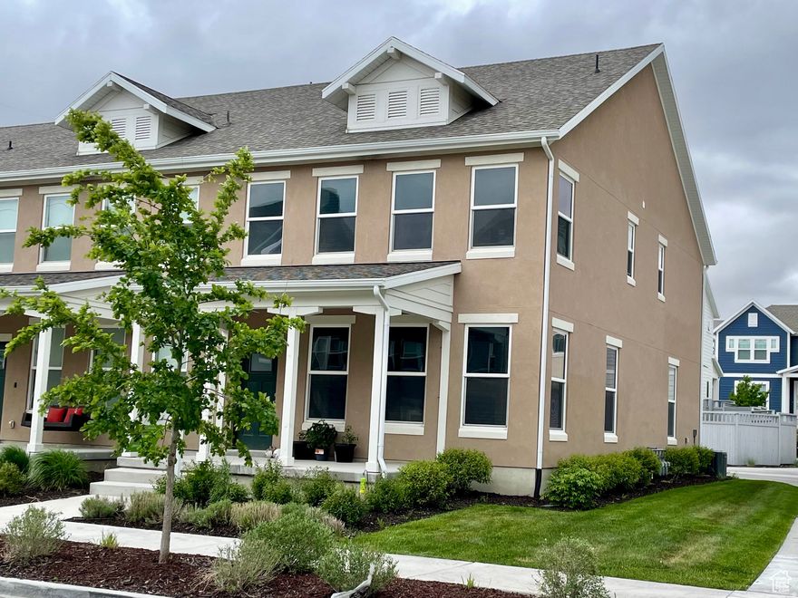 This elegant end-unit townhome that perfectly blends modern design, comfort, and functionality. The main level welcomes you with tall ceilings, a sun-filled open great room, and a stylish accent wall that creates a warm, inviting atmosphere. The entry features a built-in bench and shelving for everyday convenience and added storage. The kitchen is both beautiful and practical, offering tall cabinetry, quartz countertops, a gas stove, and a walk-in pantry-ideal for cooking and entertaining. Upstairs, the Owner's suite impresses with vaulted ceilings, serene views, and a spa-like tiled bathroom featuring dual sinks, a glass shower, and a walk-in closet. Two additional bedrooms, a full bathroom, and a dedicated laundry room with tile flooring complete the upper level. Additional highlights include a wider-than-most end-unit layout and a spacious, fully finished garage with extra storage shelving and a smart garage door system that can be controlled from your phone. Enjoy an unbeatable lifestyle in Daybreak, with access to pools, a gym, lake, parks, and miles of trails. Conveniently located near the new Bees stadium, shopping, dining, and a new elementary school-this home offers comfort, style, and vibrant community living all in one.